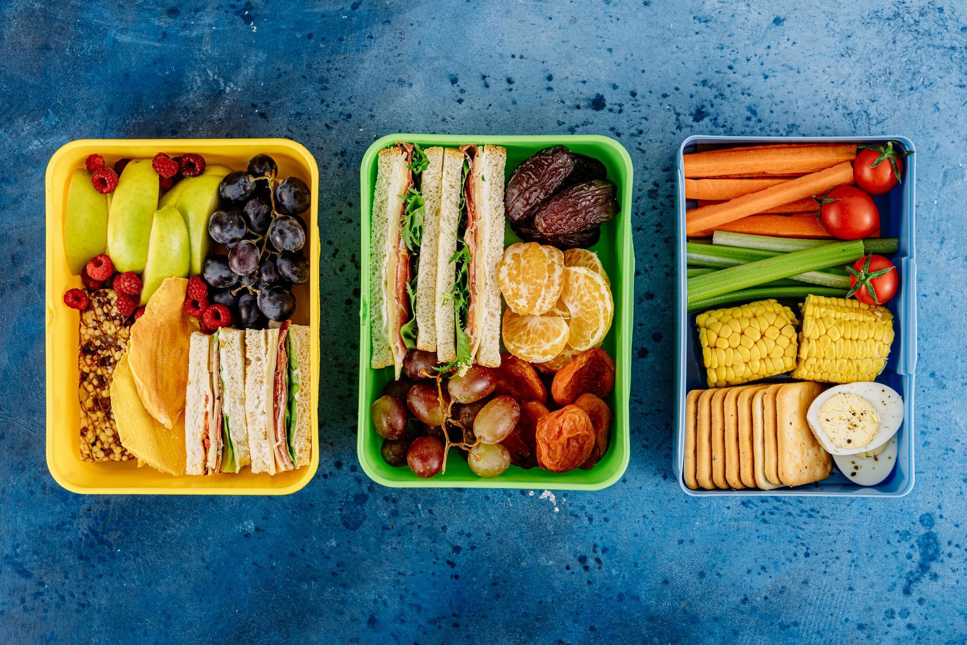 Colorful, nutritious meal prep containers filled with fruits, sandwiches, and snacks, ideal for balanced diets.