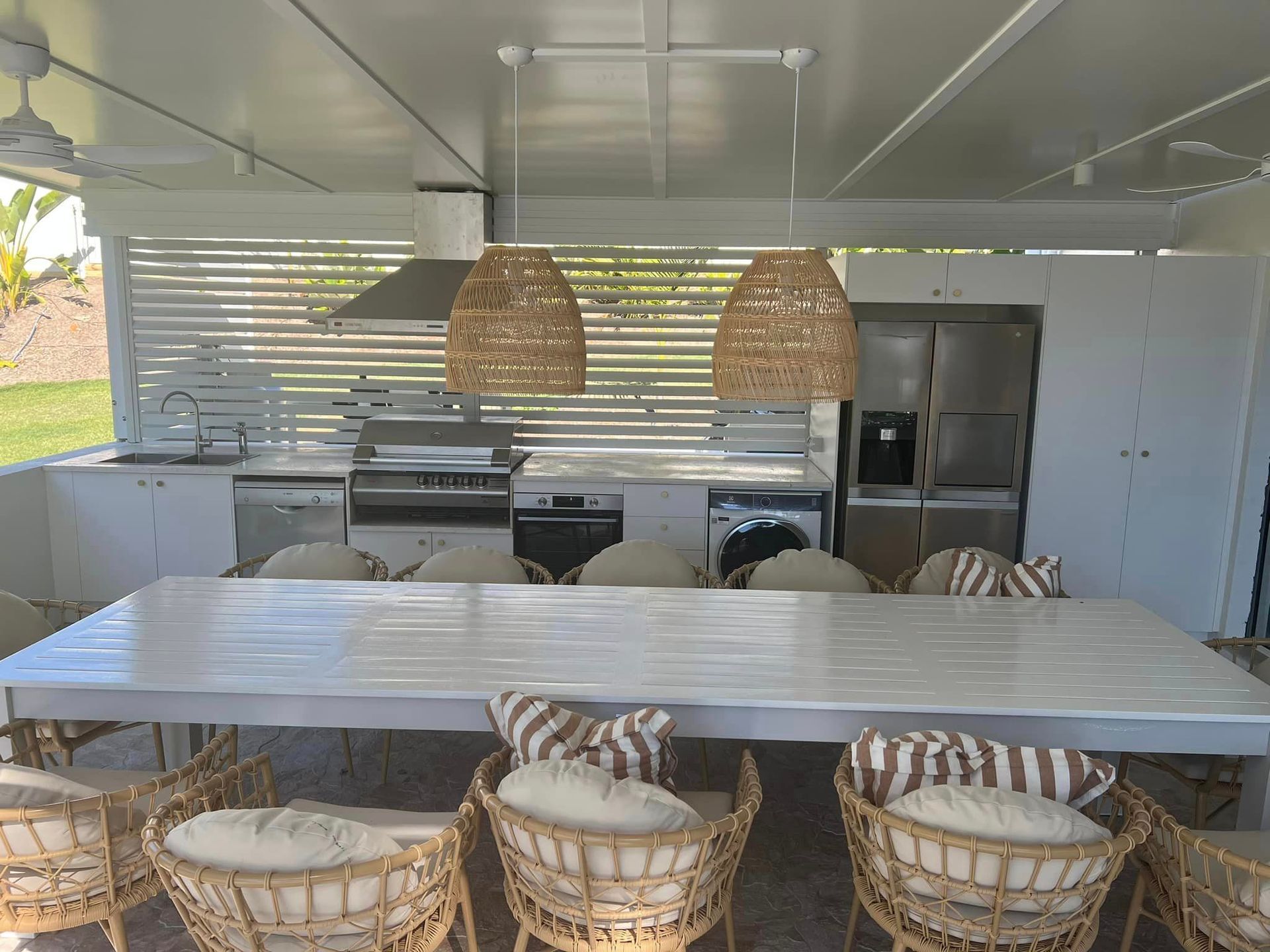 There is a large table and chairs in the kitchen.