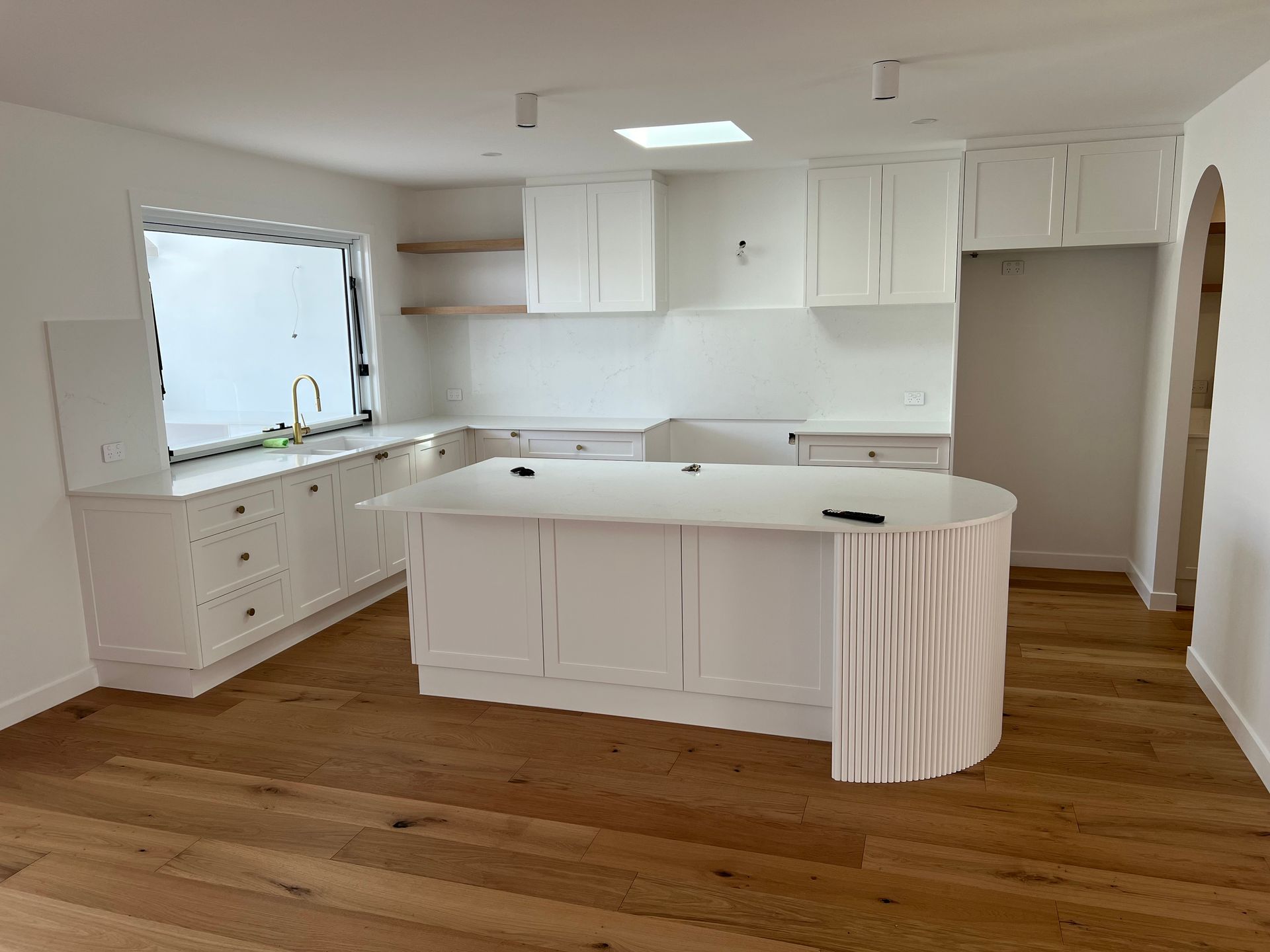 There is a large island in the middle of the kitchen.