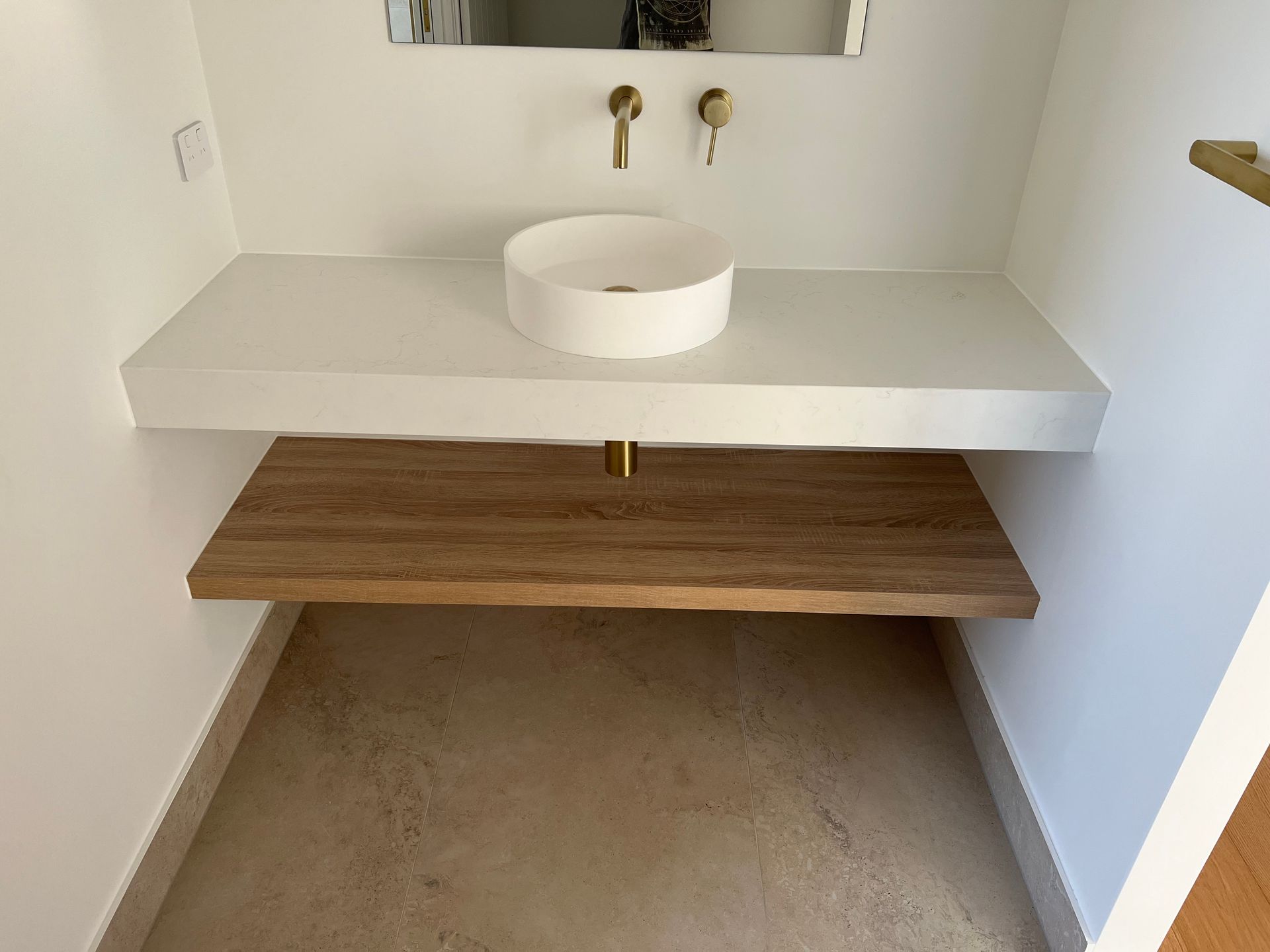A bathroom with a sink and a mirror on the wall.