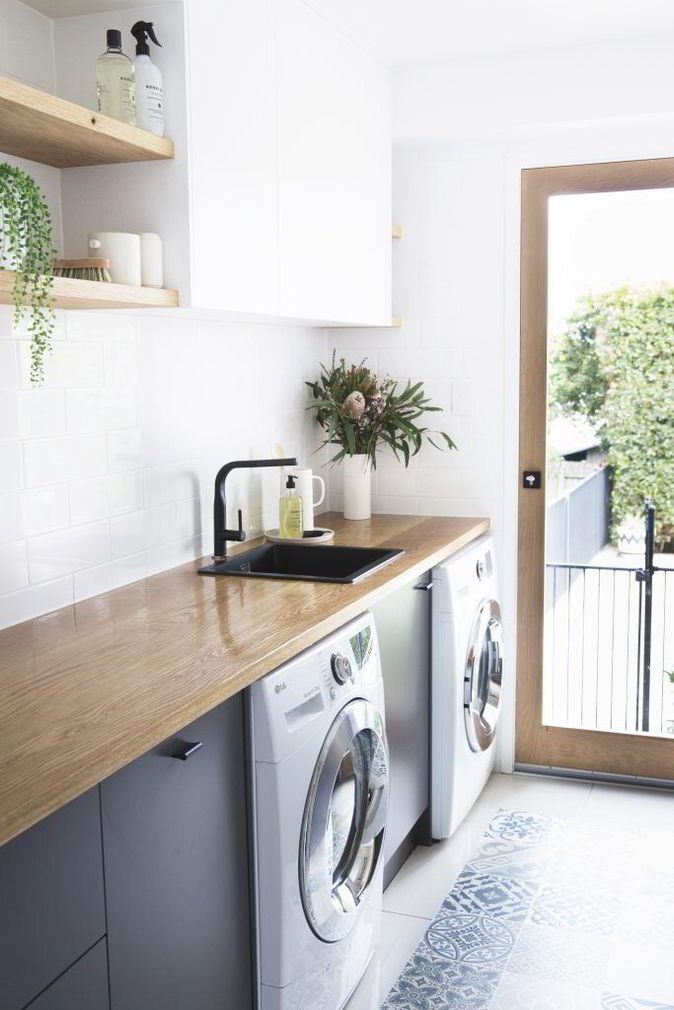 A laundry room with a washer and dryer and a sink.