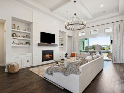 A living room with a couch , fireplace and television.