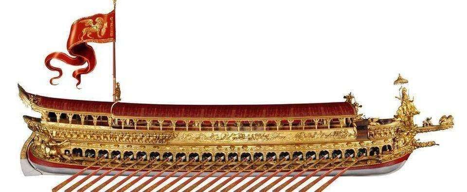 A model of a golden Venetian Bucentaur galley, featuring red awnings and a red flag with a gold winged lion.