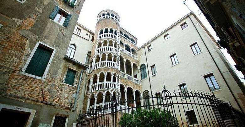 The Contarini del Bovolo Palace in Venice, Italy, featuring its famous multi-story external spiral staircase and arches.