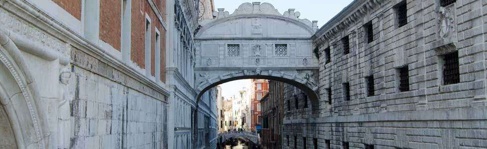 The Bridge of Sighs in Venice, Italy, spanning a narrow canal between historic stone buildings.