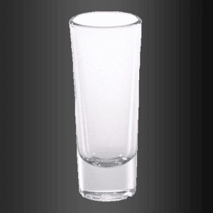 Un vaso de chupito transparente reposa sobre una superficie negra.