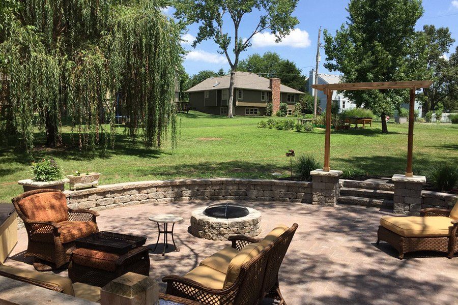 outdoor living in style with a patio, fire pit and small retaining wall