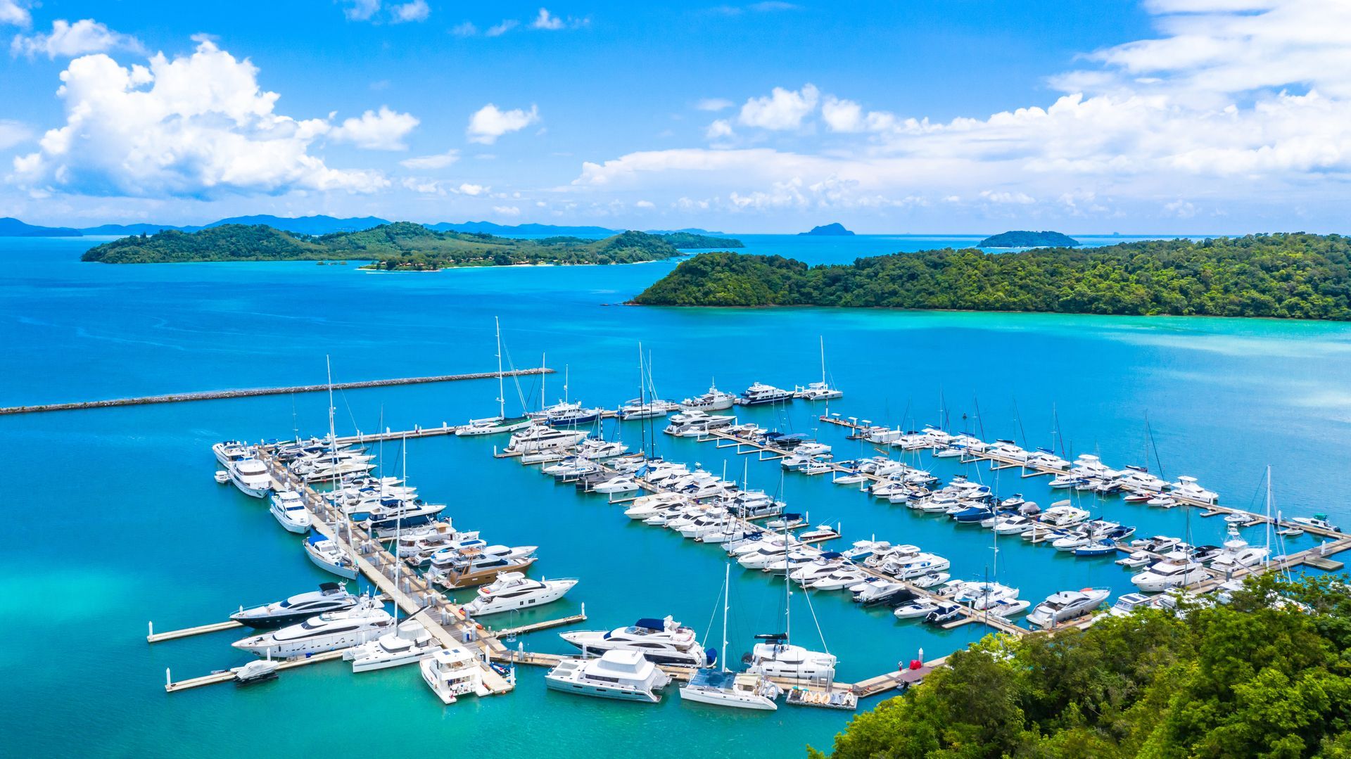 Beautiful port yachts and boats in marina bay with bulk internet and managed wifi, Aerial view of yachts and boat in the marina clear water with blue sky background