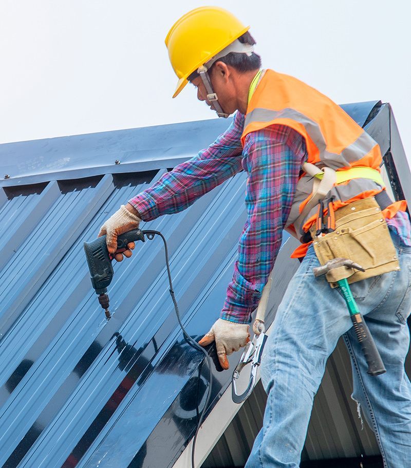 Worker Installing New Metal Roof
