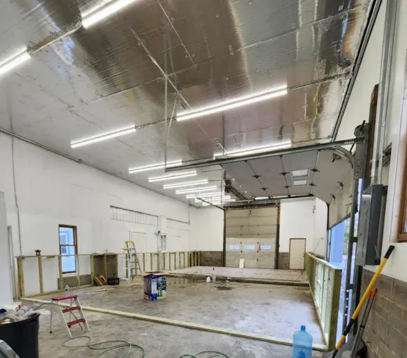 A kitchen with white cabinets and a large island in the middle.