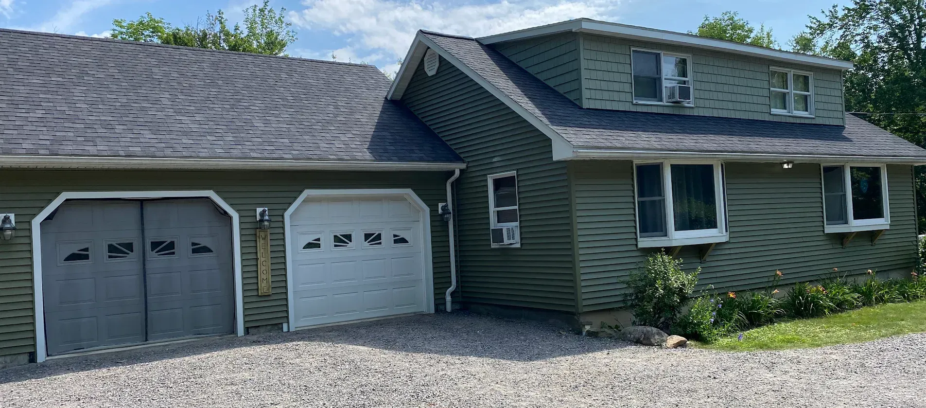 A kitchen with white cabinets and a large island in the middle.