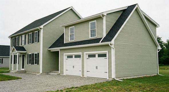 A kitchen with white cabinets and a large island in the middle.