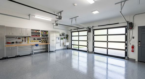 A kitchen with white cabinets and a large island in the middle.