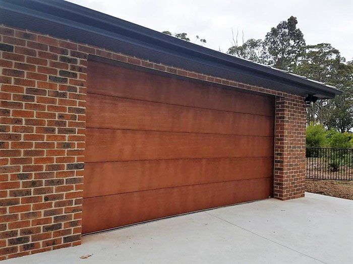 wooden garage door on brick house