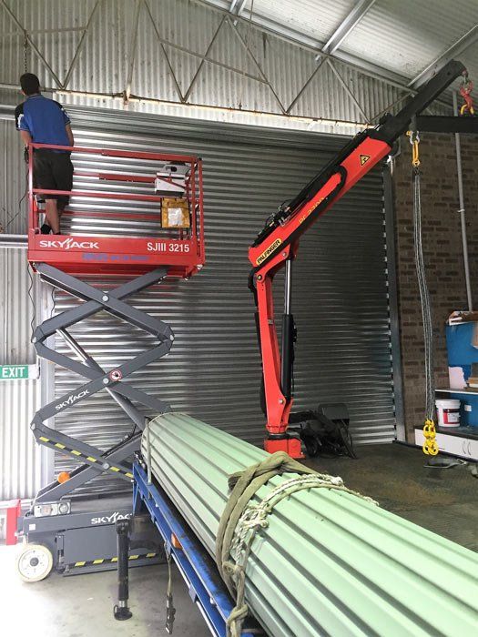 man working on closed garage door