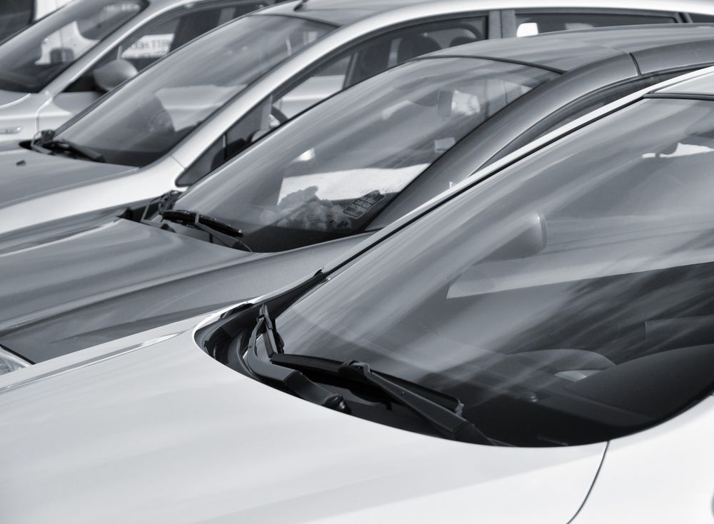A close-up, angled view of a row of parked cars, focusing on their windshields and hoods  — Cartech Australia in Albury, NSW