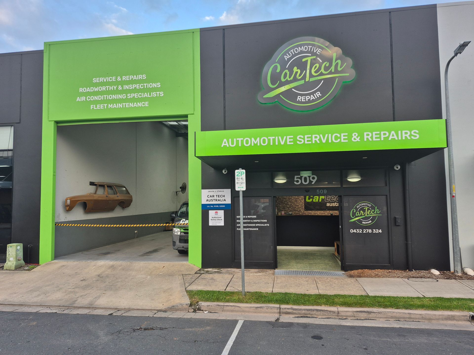 CarTech automotive shop with green and black facade. Car repair bay visible, sign says Automotive Service & Repairs — Cartech Australia in Wodonga, NSW