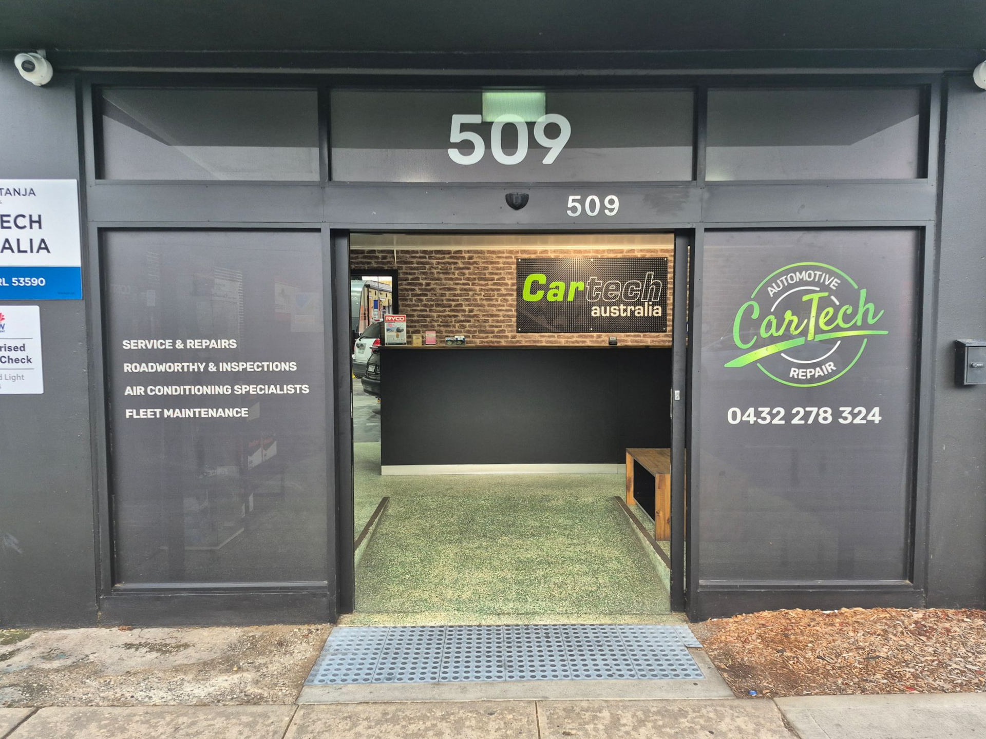 Exterior of CarTech auto repair shop at 509, with glass door and green logo — Cartech Australia in Albury, NSW