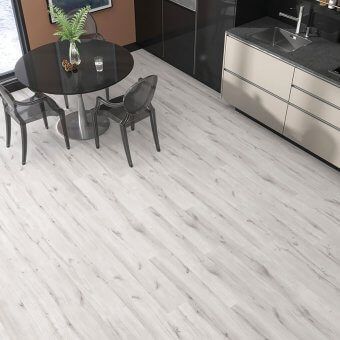 A kitchen with a round table and chairs and a sink.