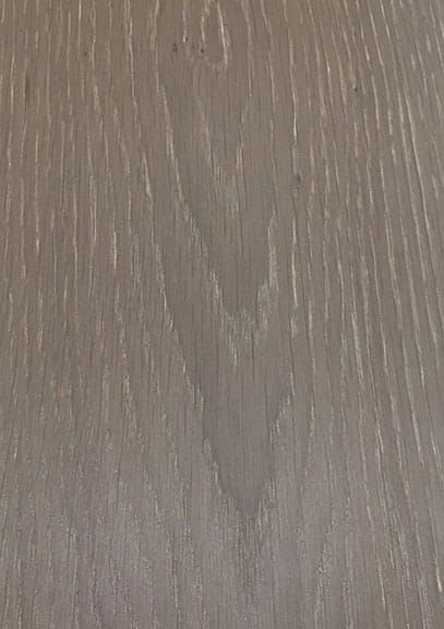 A close up of a piece of wood showing the grain and texture.