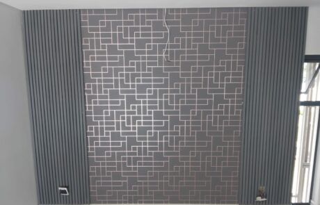 A wall with a geometric pattern on it in a room.