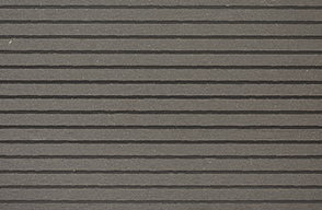 A close up of a gray wall with a striped pattern.