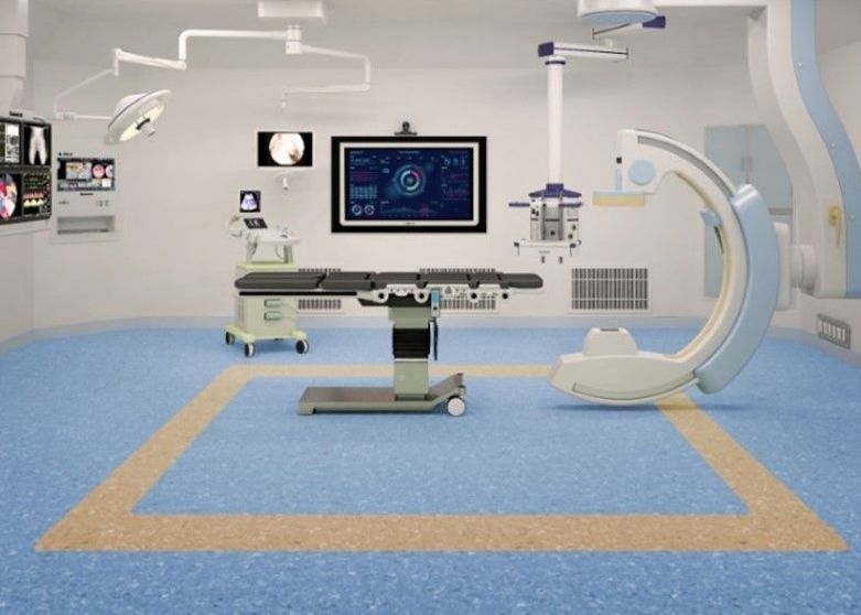 An operating room with a surgical table and a ct scan machine.