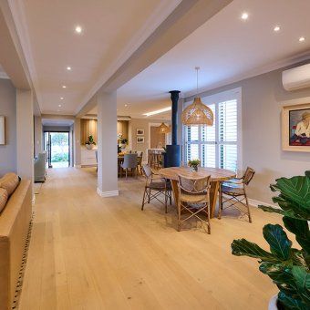 There is a table and chairs in the middle of the room.