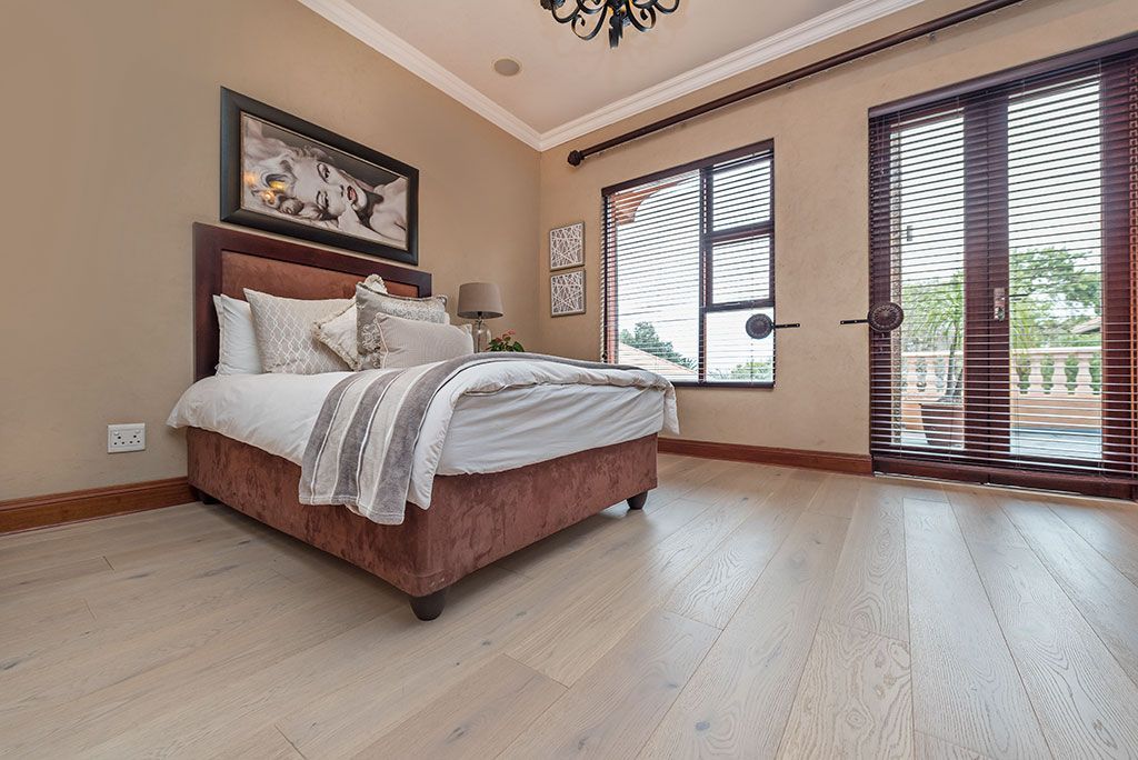 A bedroom with a bed , sliding glass doors and a balcony.