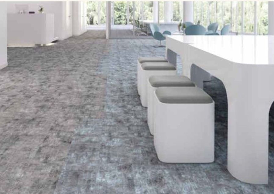 A conference room with a long table and stools.