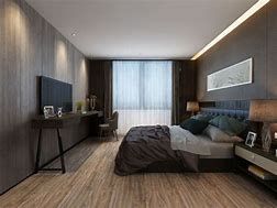 A bedroom with a large bed , a desk , a television and a large window.