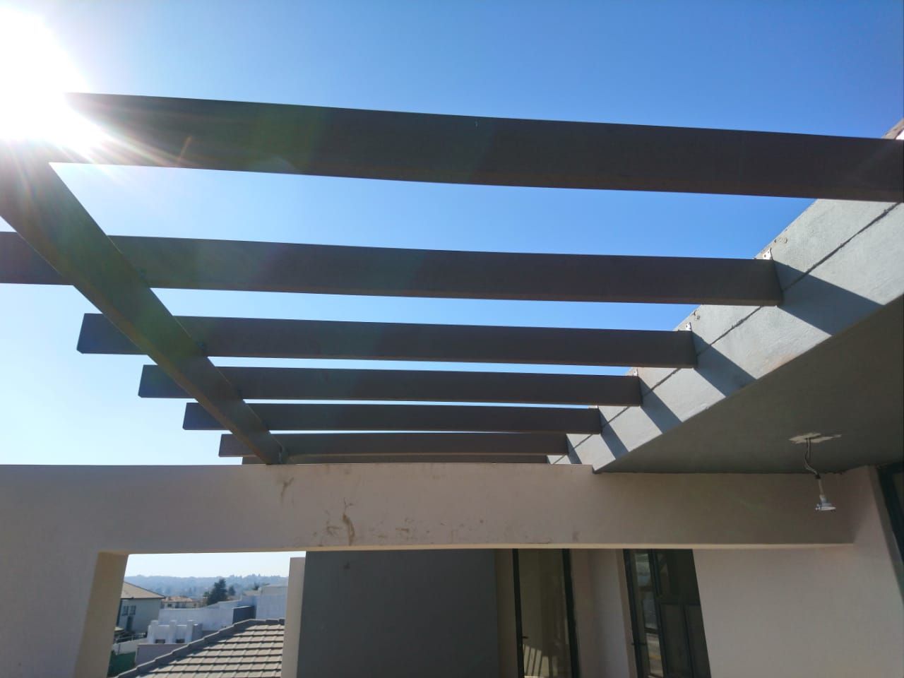 The sun is shining through the roof of a building