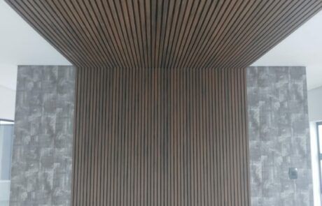 A room with a wooden wall and a wooden ceiling.