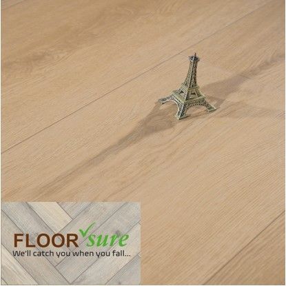 A small eiffel tower is sitting on a wooden floor