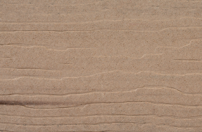 A close up of a piece of cardboard showing the texture of the cardboard.