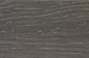 A close up of a gray surface with waves on it.