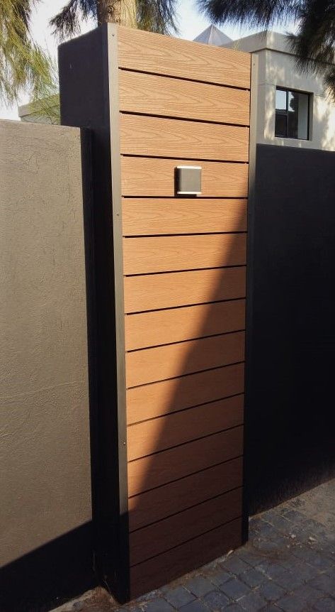 A wooden fence with a mailbox on it