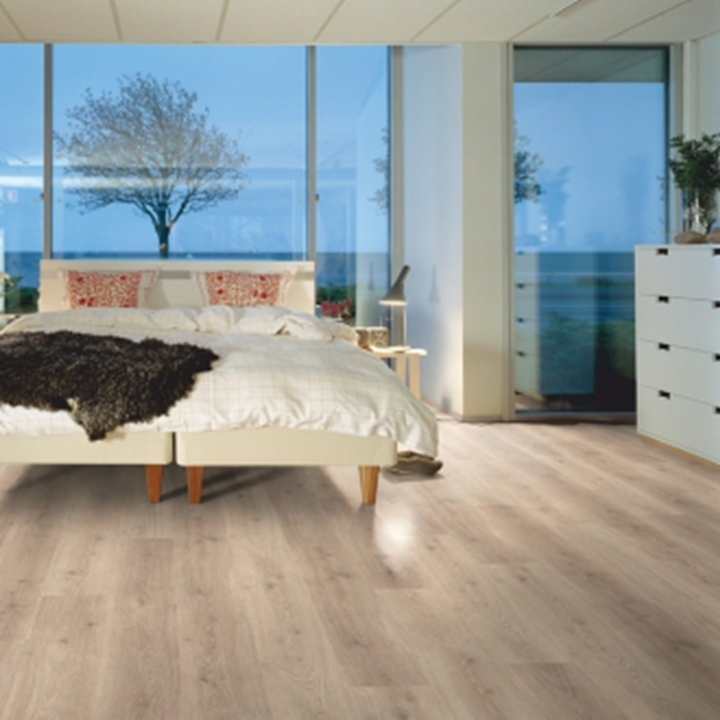 A bedroom with a large bed and a view of the ocean