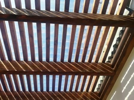 Looking up at the sky through a wooden structure