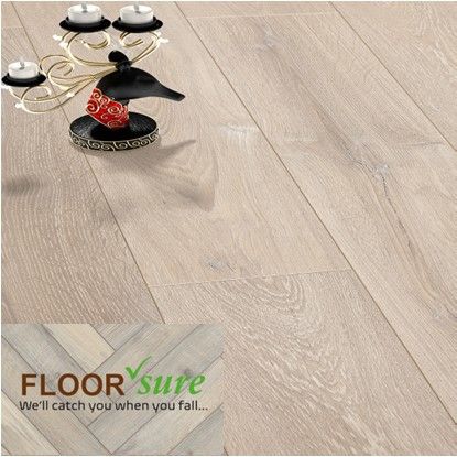 A candle holder is sitting on top of a wooden floor.