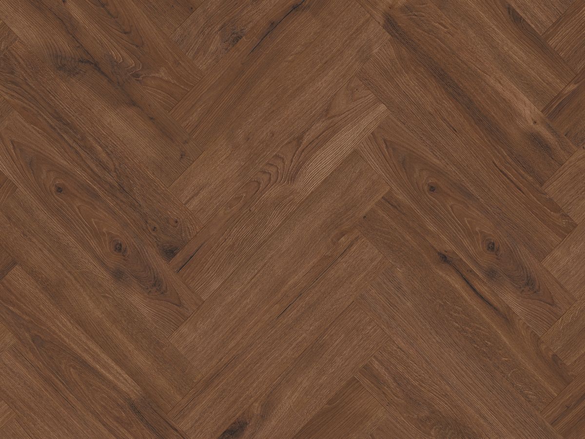 A close up of a wooden floor in a herringbone pattern.