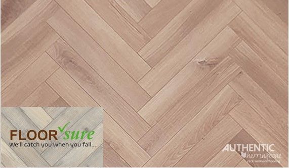 A close up of a herringbone wood floor