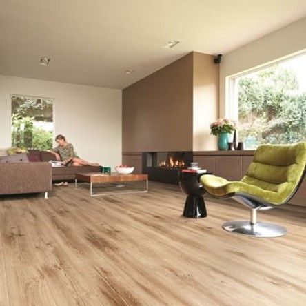 A living room with a couch , chair , coffee table and fireplace.