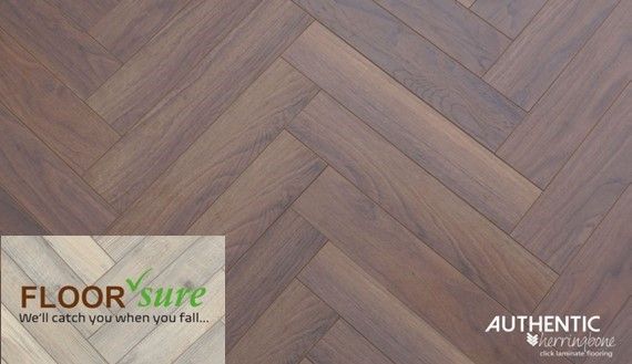A close up of a herringbone wood floor