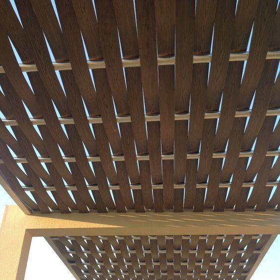 The ceiling of a pergola made of wood and metal