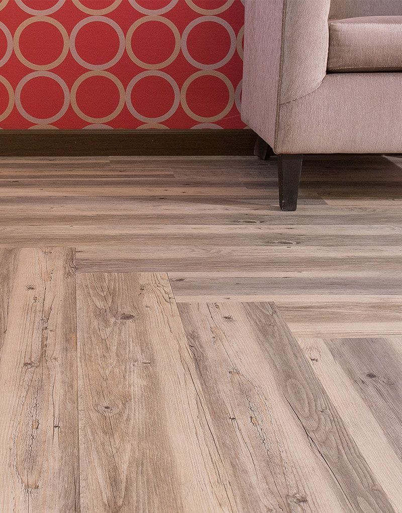 A living room with a chair and a wooden floor