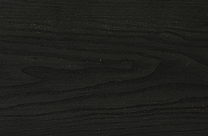 A close up of a black wood grain texture.