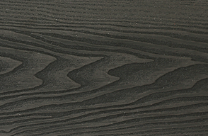 A close up of a piece of black wood with a grain pattern.