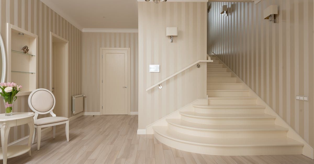 A hallway with stairs leading up to the second floor of a house.
