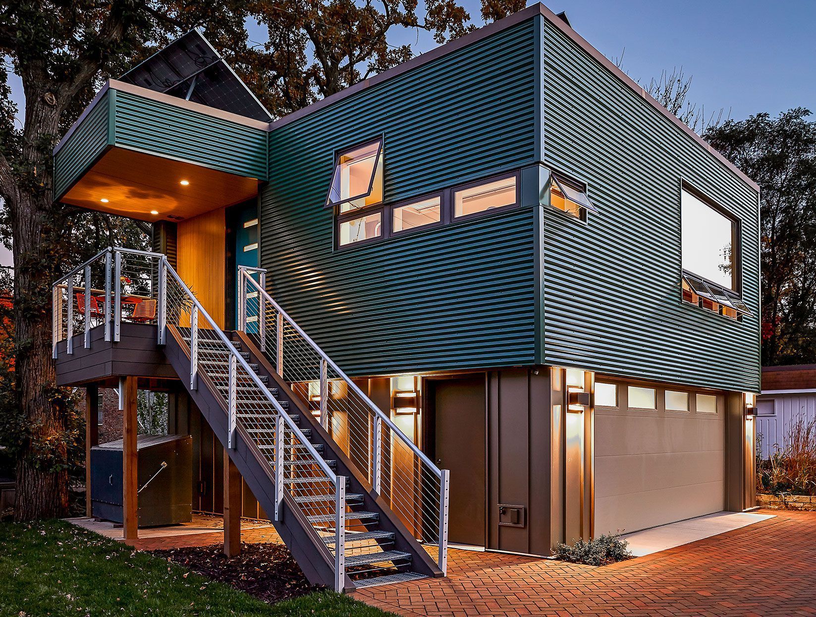 A green house with stairs leading up to it